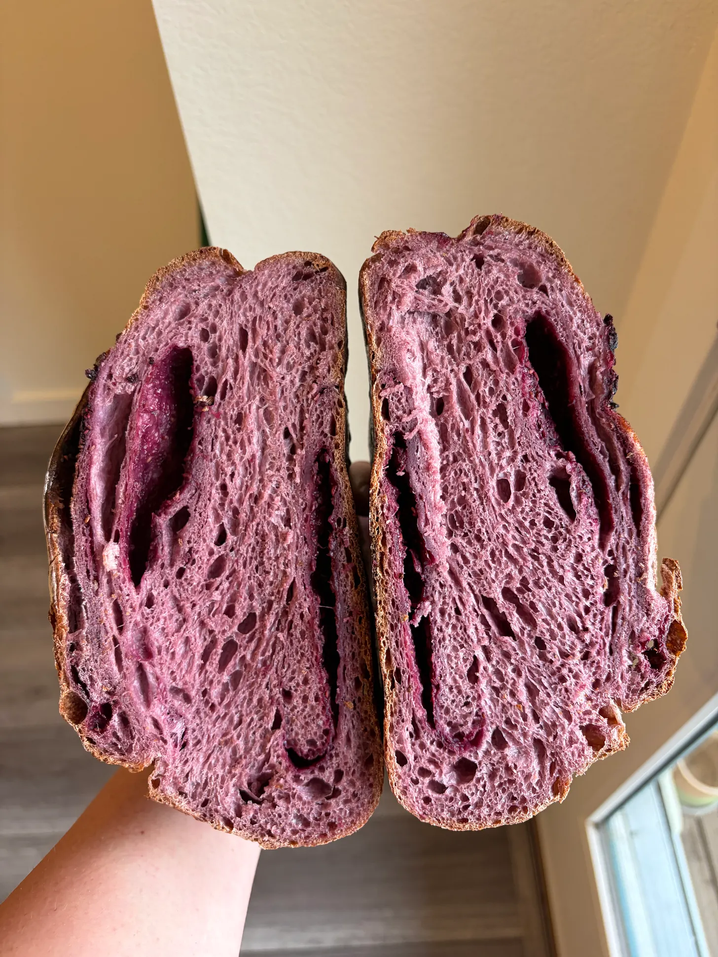 Tri berry sourdough dough being shaped with berry filling